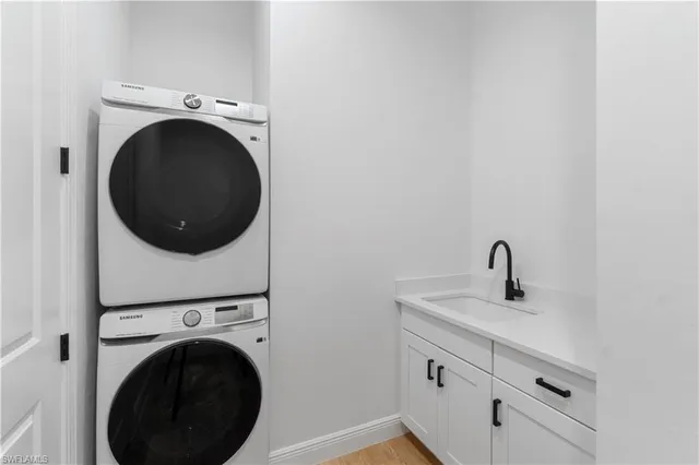 a utility room with sink dryer and washer