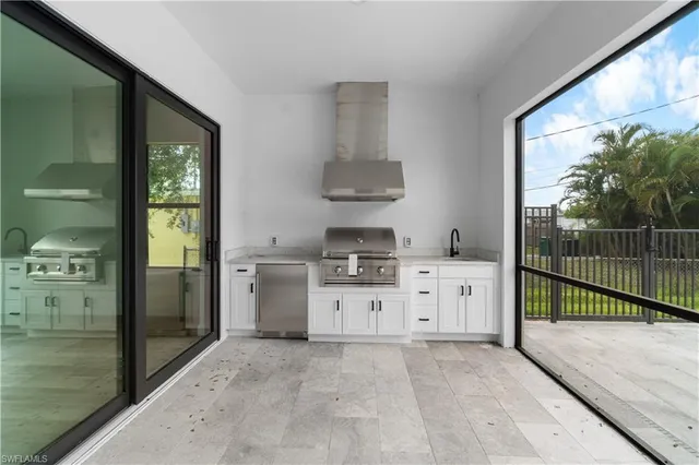 a kitchen with a stove a refrigerator and a sink