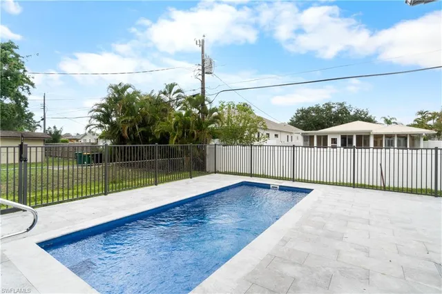 a view of a backyard with a fence