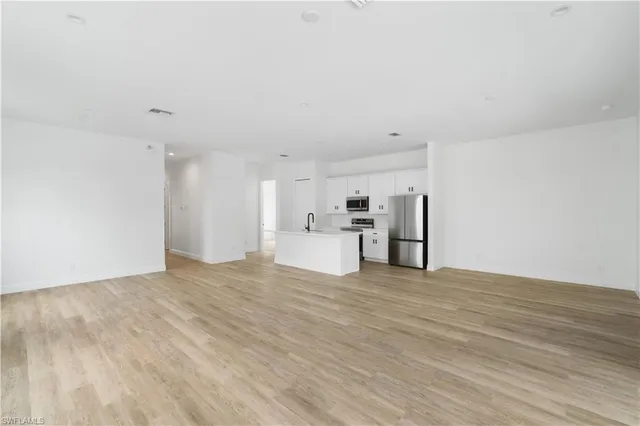 a view of a kitchen with a sink and a refrigerator