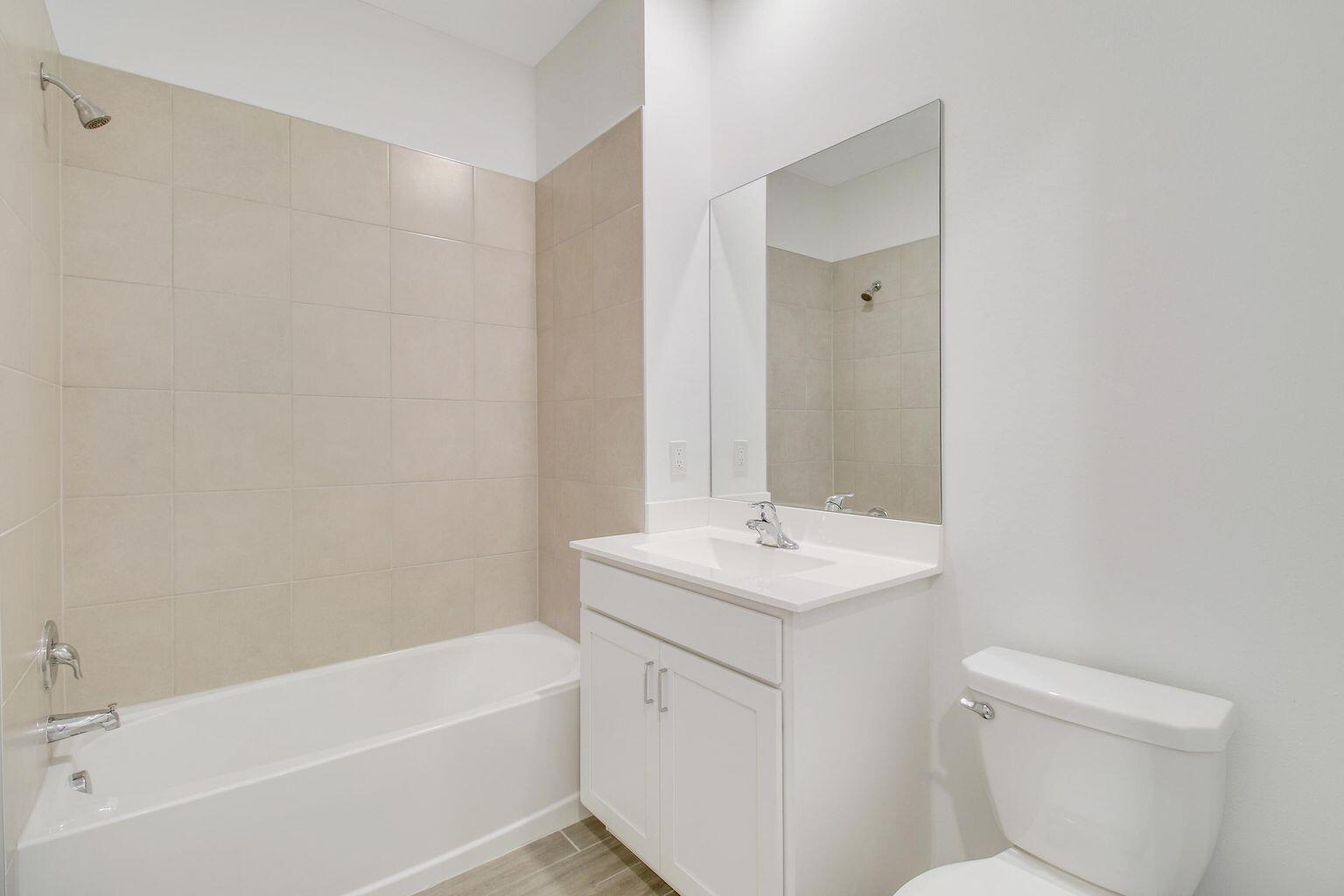 14556 Wiley Range Road Delray Beach, FL 33446 - Photo 13 of 29 a bathroom with a sink a toilet and shower