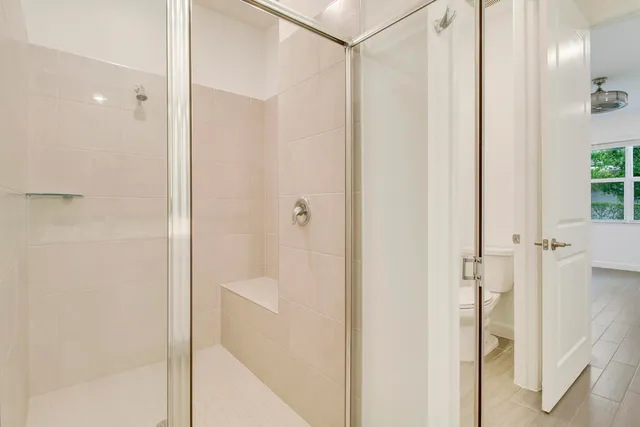a bathroom with a glass shower door