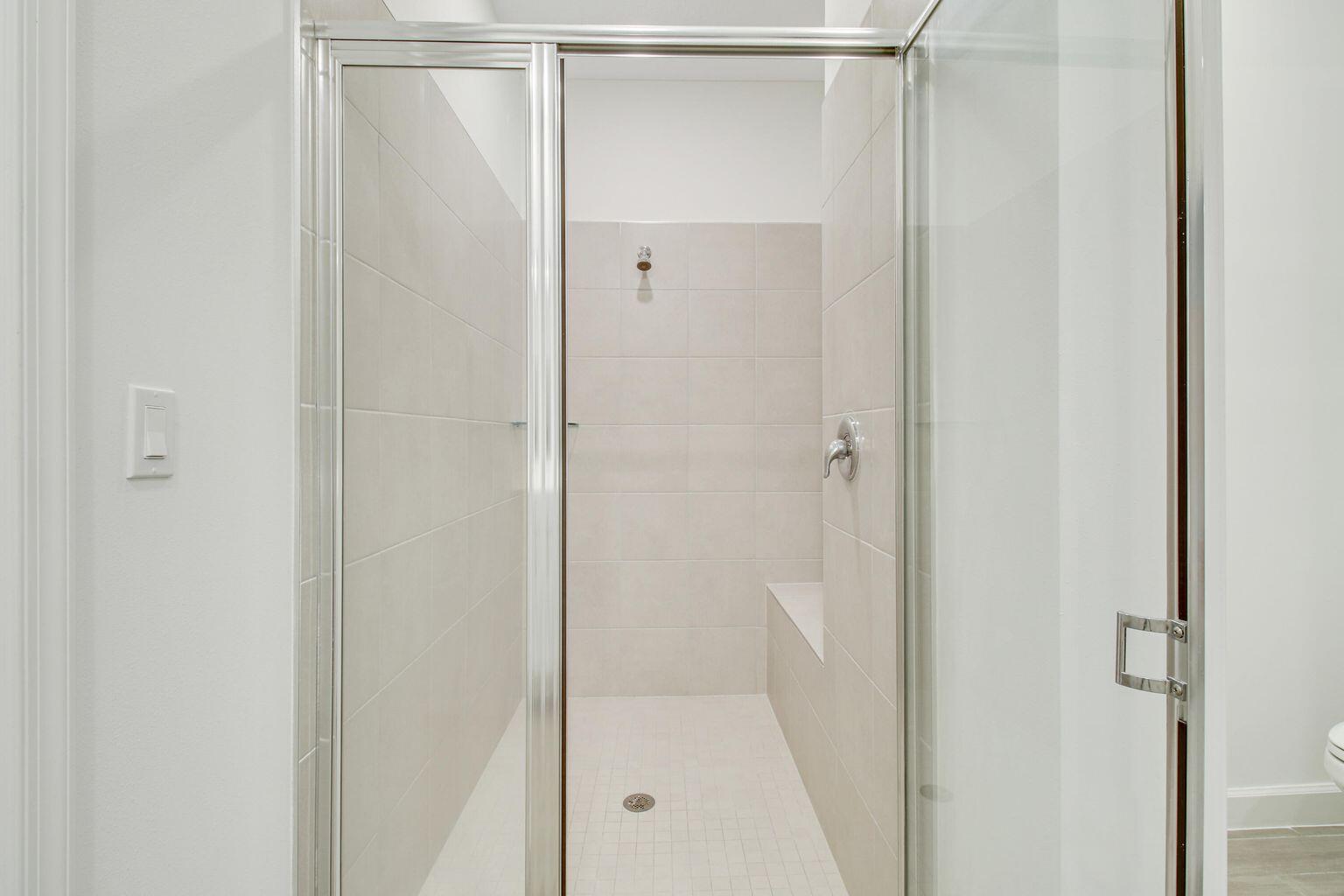 14556 Wiley Range Road Delray Beach, FL 33446 - Photo 20 of 29 a bathroom with a glass shower door
