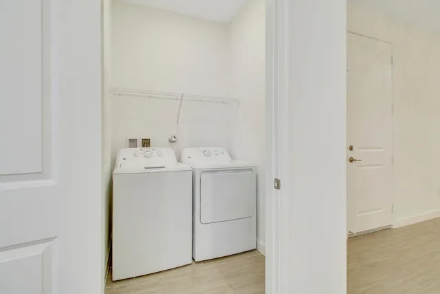 an empty room with a ceiling fan and windows