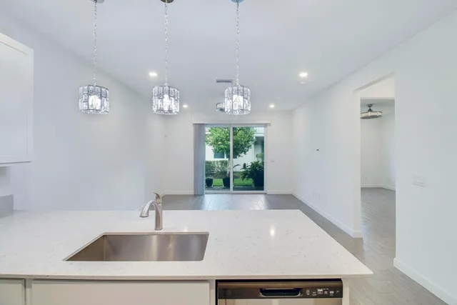 a view of kitchen with kitchen island and stainless steel appliances