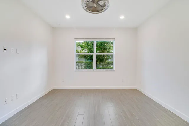 a front view of a house with garden and plants