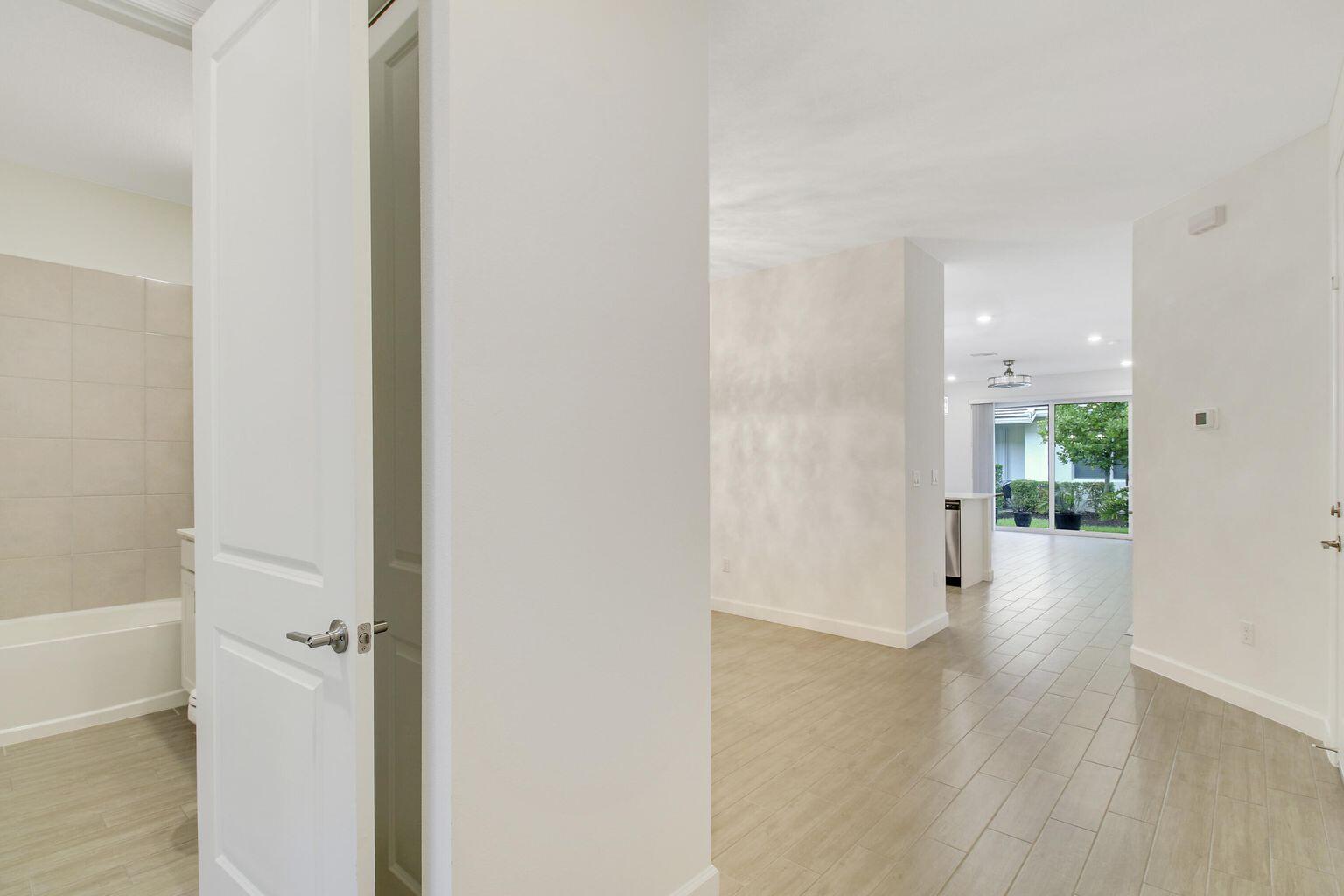 14556 Wiley Range Road Delray Beach, FL 33446 - Photo 10 of 29 a view of a hallway with wooden floor