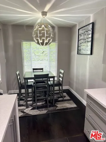 a view of a dining room with furniture and chandelier