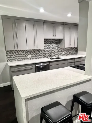 a kitchen with a sink stove and cabinets
