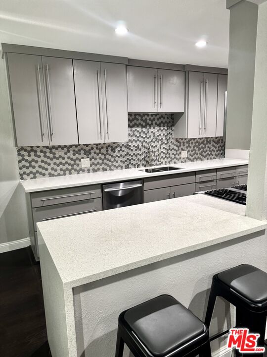 50 Elm Avenue, Unit 5 Long Beach, CA 90802 - Photo 24 of 44 a kitchen with a stove a sink and a refrigerator