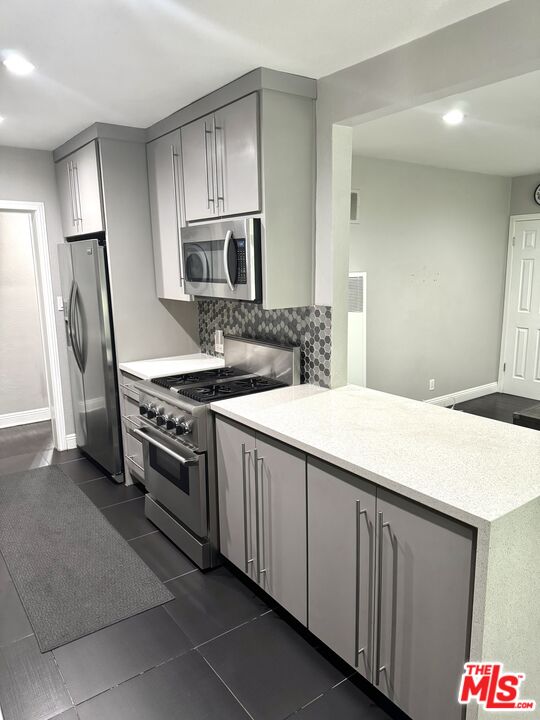 50 Elm Avenue, Unit 5 Long Beach, CA 90802 - Photo 26 of 44 a kitchen with stainless steel appliances a sink stove and refrigerator