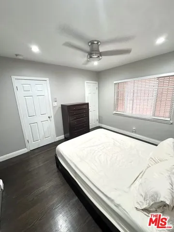a large bed sitting in a bedroom next to a lamp