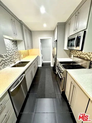a kitchen with a stove and a sink
