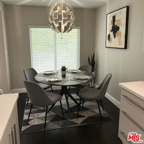 a view of a dining room with furniture and chandelier