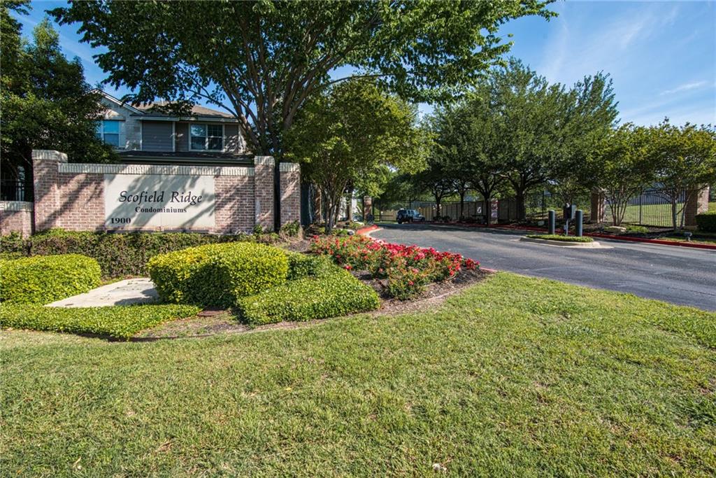 1900 Scofield Ridge Parkway, Unit 5501 Austin, TX 78727 - Photo 20 of 21 A welcoming entry sign fronts a community with lush landscaping and mature trees.