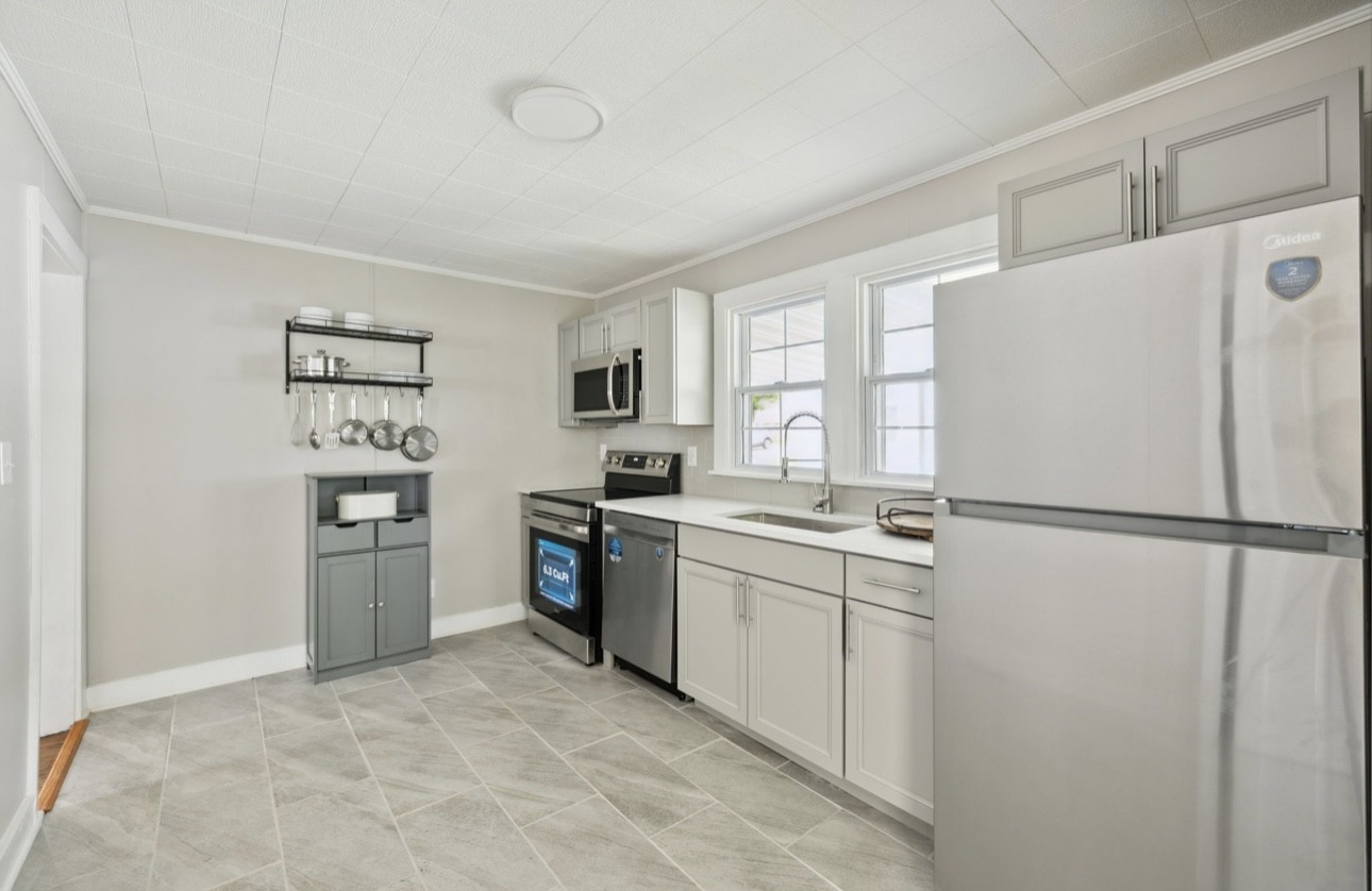 1901 Cherry Street Columbia, TN 38401 - Photo 28 of 58 a kitchen with stainless steel appliances a refrigerator sink and cabinets