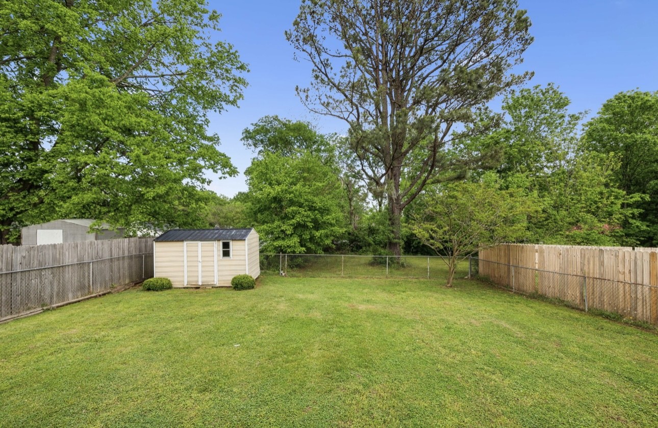 1901 Cherry Street Columbia, TN 38401 - Photo 42 of 58 a backyard of a house with large trees and wooden fence