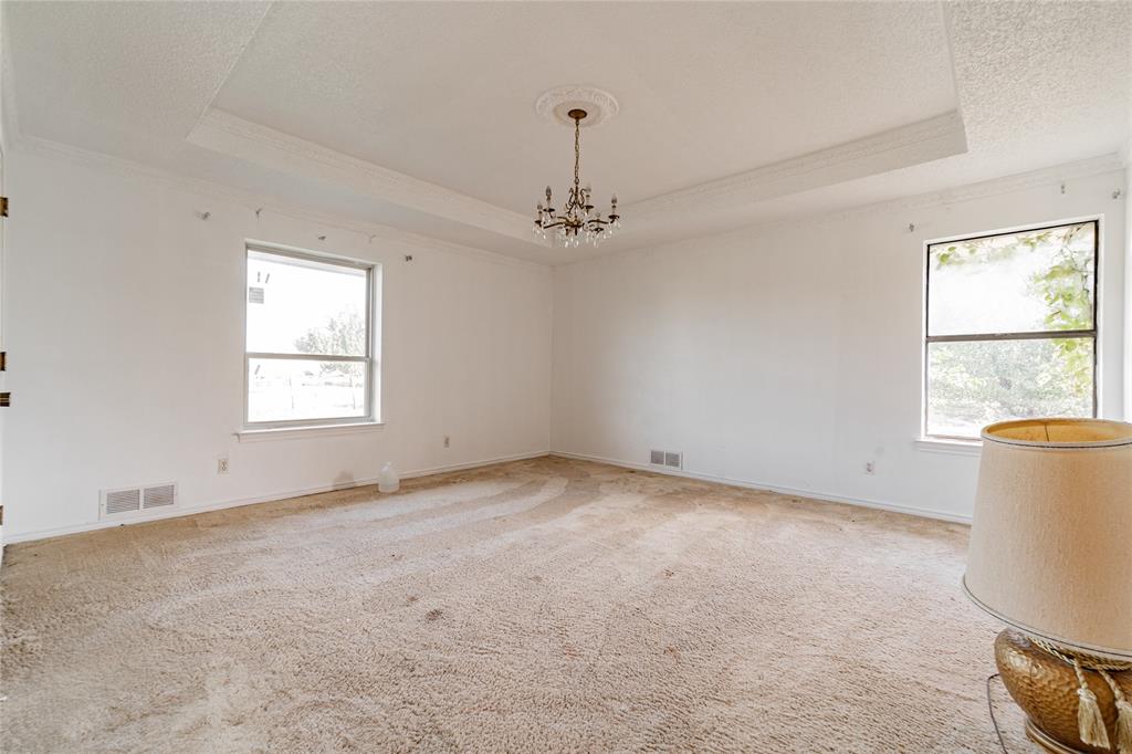 4320 Hickox Road Rowlett, TX 75089 - Photo 24 of 37 Tray ceiling with crown molding, decorative ceiling medallion, and a chandelier