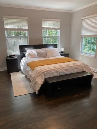 a bed sitting in a bedroom next to a window