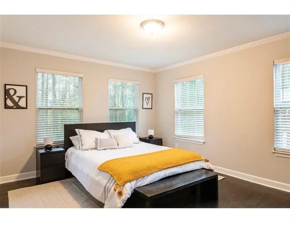 a bedroom with a bed window and table