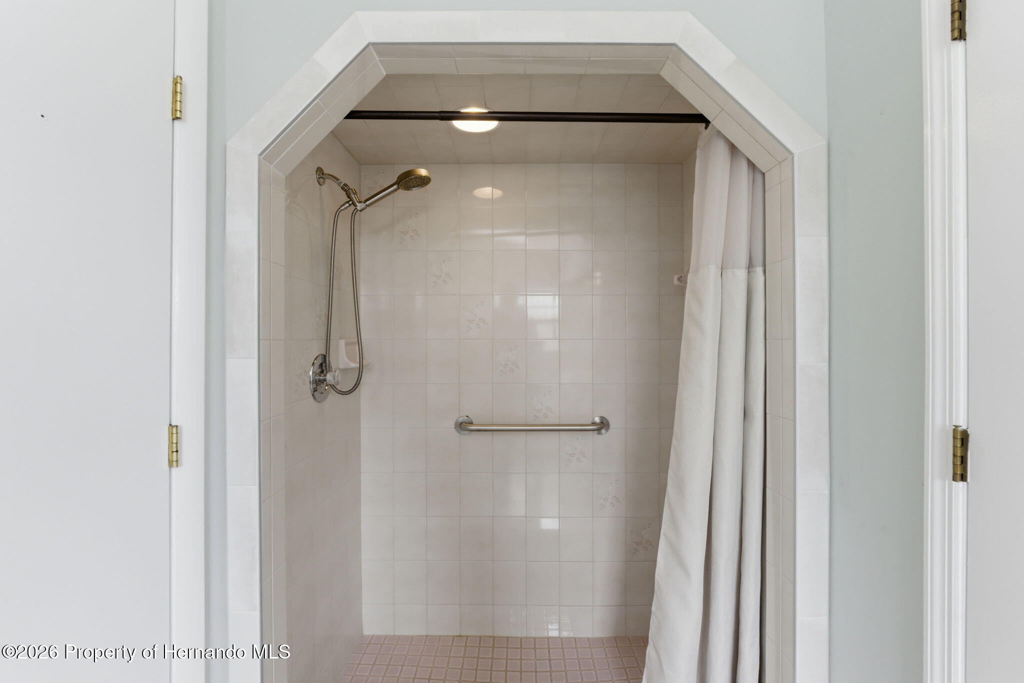4966 Keysville Avenue Spring Hill, FL 34608 - Photo 30 of 50 a bathroom with a glass shower door