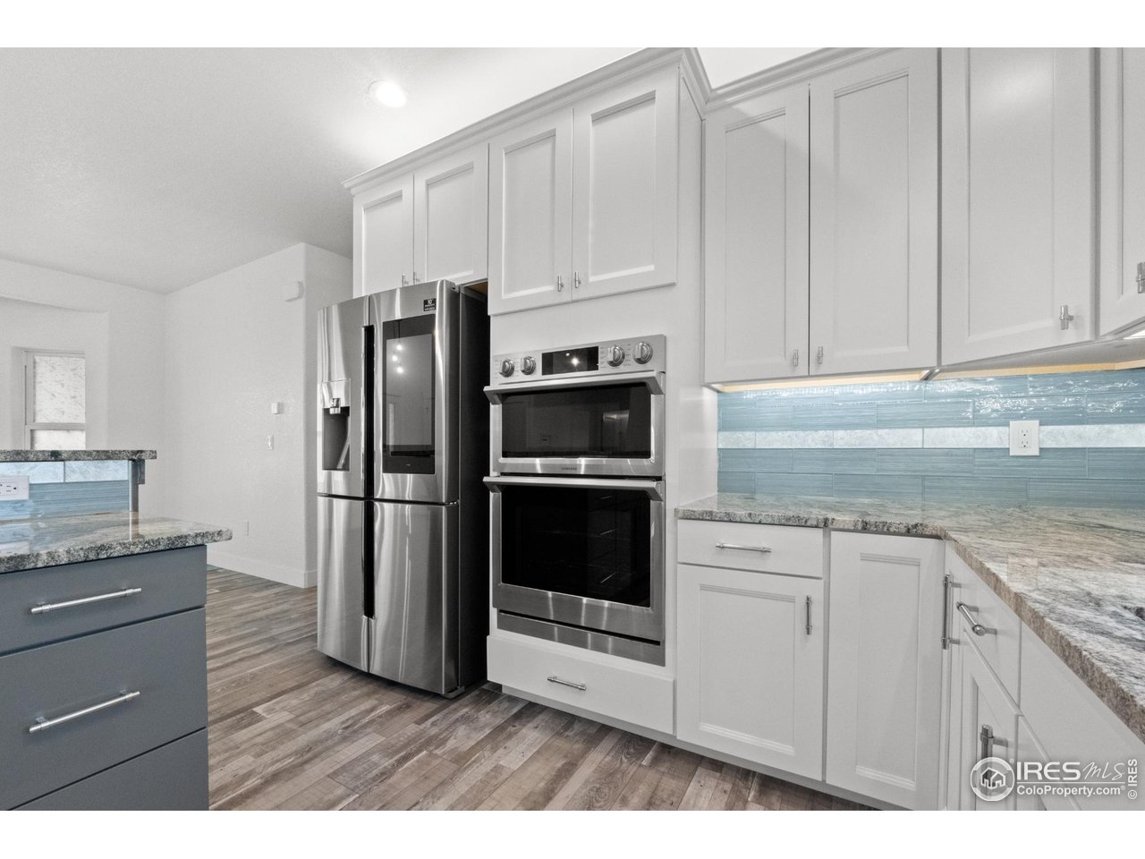 7908 P 3 Road Wiggins, CO 80654 - Photo 11 of 40 High-end 4-door smart refrigerator combines style, technology, and spacious storage.