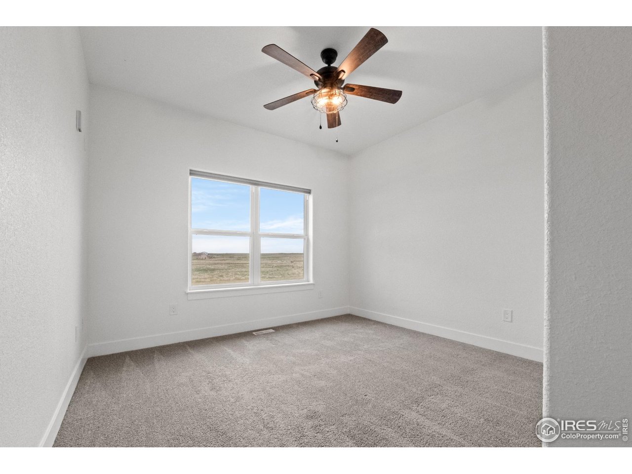 7908 P 3 Road Wiggins, CO 80654 - Photo 17 of 40 Cozy second bedroom with soft natural light and ample closet space.