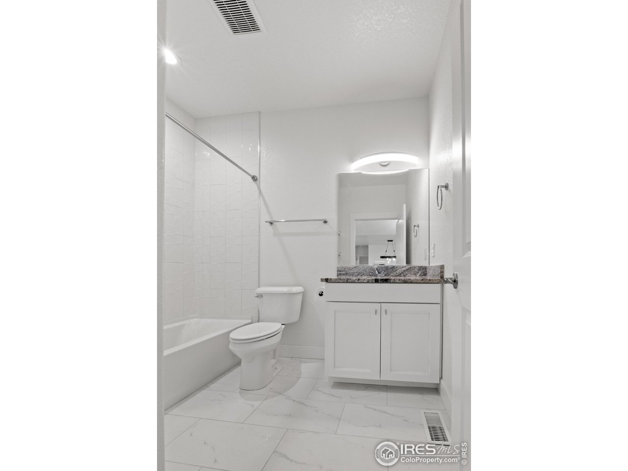 7908 P 3 Road Wiggins, CO 80654 - Photo 19 of 40 Main level full bath featuring modern fixtures and a clean, contemporary design.