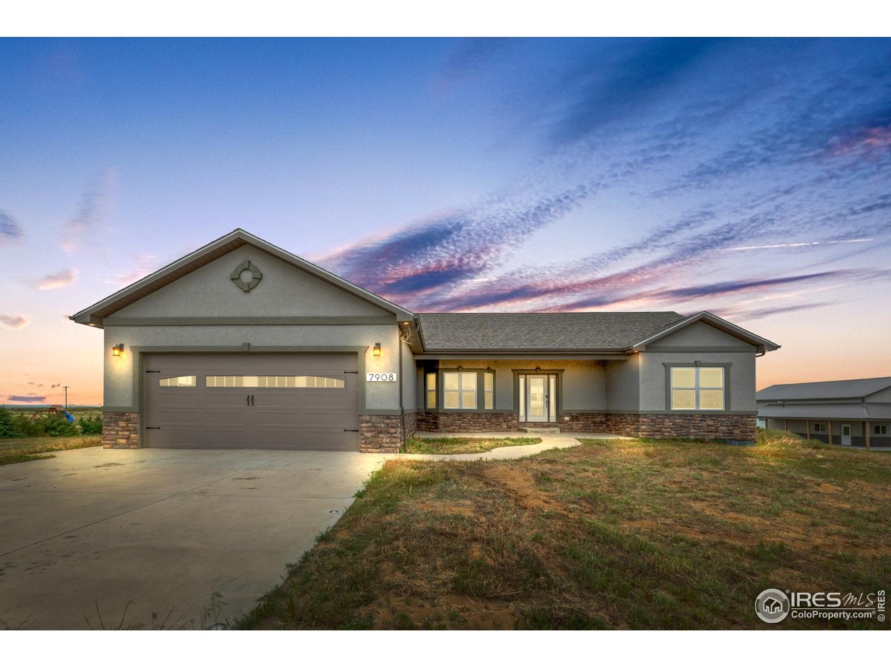 7908 P 3 Road Wiggins, CO 80654 - Photo 2 of 40 Beautiful front view of the modern ranch-style home with oversized garage and covered entry.