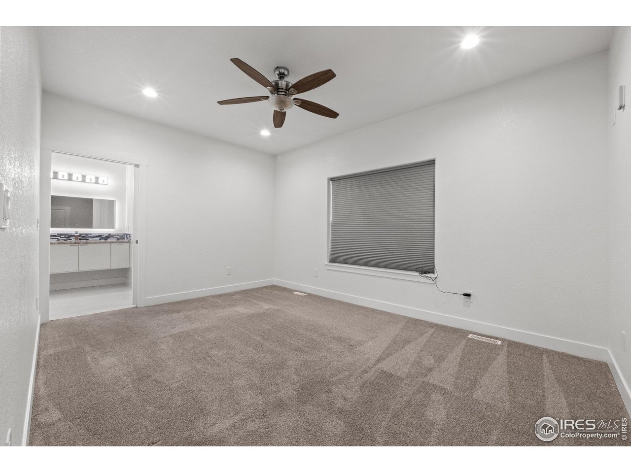 7908 P 3 Road Wiggins, CO 80654 - Photo 21 of 40 Spacious master suite with serene ambiance, walk-in closet, and luxurious ensuite access.