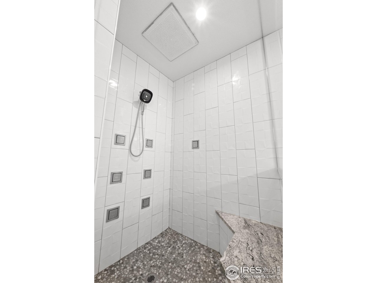 7908 P 3 Road Wiggins, CO 80654 - Photo 26 of 40 Custom rain shower with body sprayers delivers a rejuvenating, full-body spa experience.