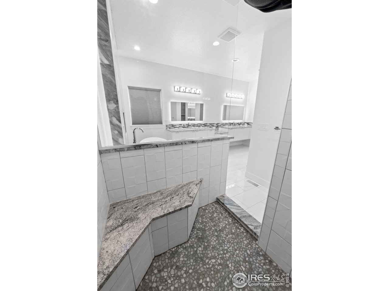 7908 P 3 Road Wiggins, CO 80654 - Photo 27 of 40 Beautifully tiled walk-in shower with granite bench for comfort and style.