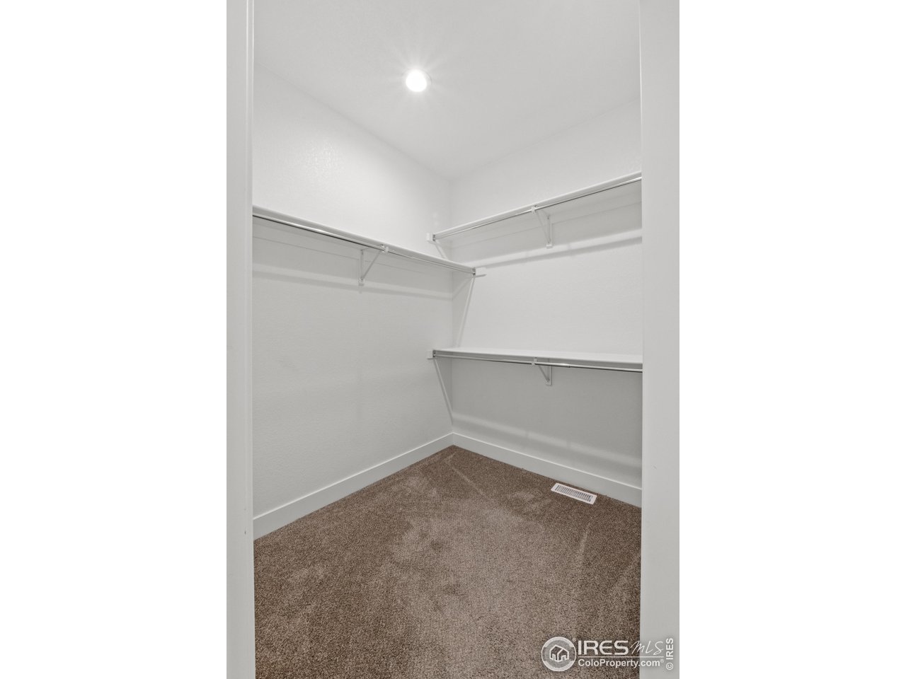 7908 P 3 Road Wiggins, CO 80654 - Photo 28 of 40 Spacious walk-in closet with built-in shelving for organized, functional storage.