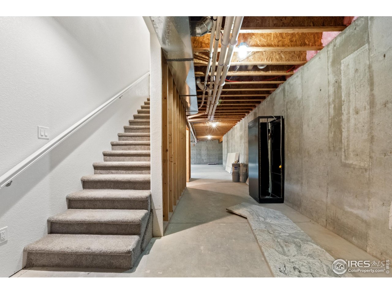 7908 P 3 Road Wiggins, CO 80654 - Photo 29 of 40 Wide stairway leads to the full walkout basement with 9' ceilings and endless potential.