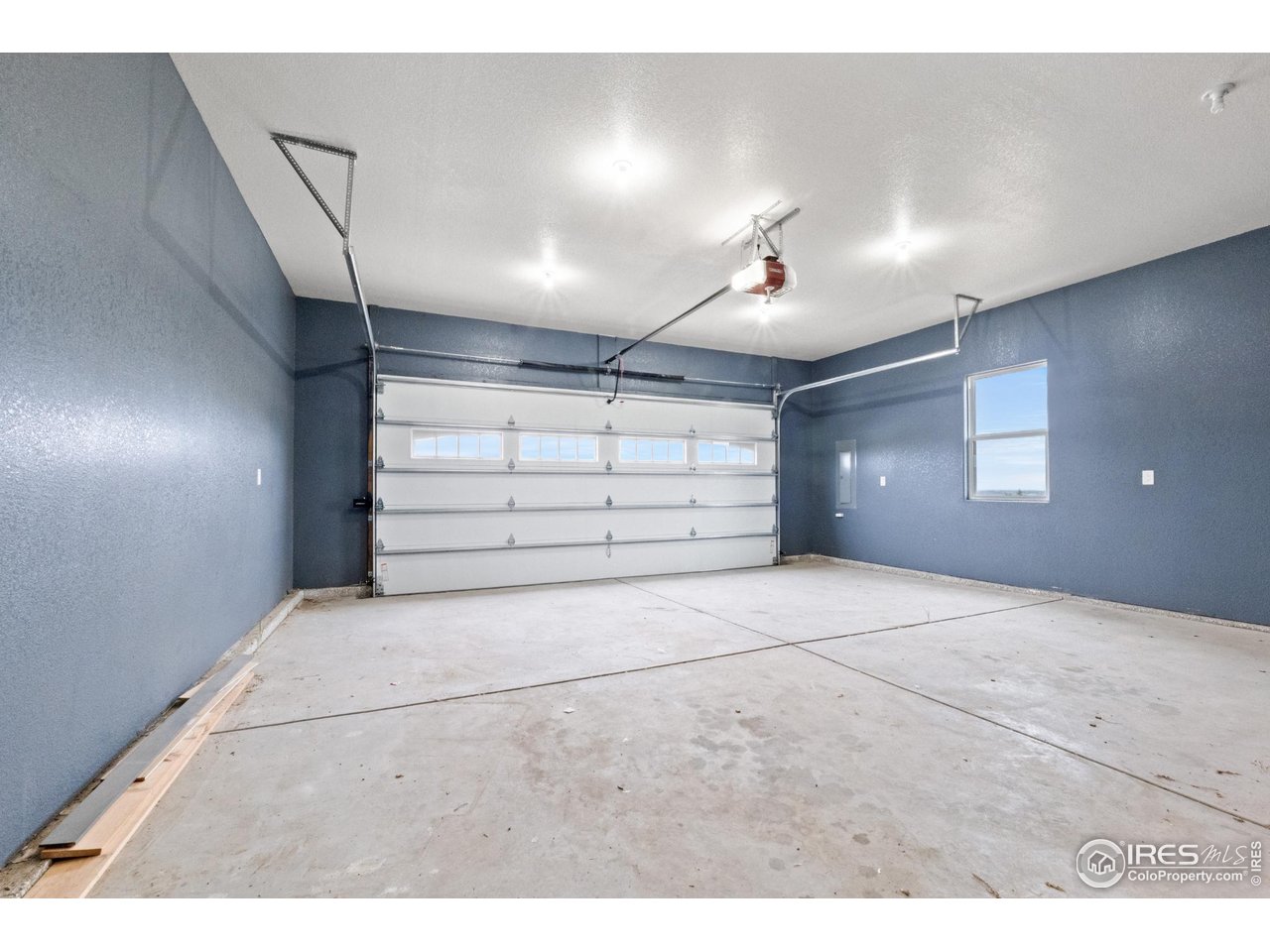 7908 P 3 Road Wiggins, CO 80654 - Photo 31 of 40 Oversized two-car garage offers ample space for vehicles, tools, and storage.