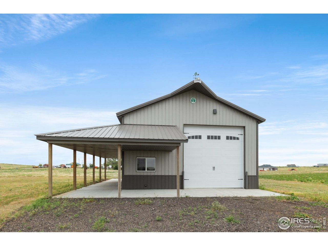 7908 P 3 Road Wiggins, CO 80654 - Photo 34 of 40 Impressive 48'x30' heated and insulated shop with oversized doors and clean curb appeal with 14' overhead door.