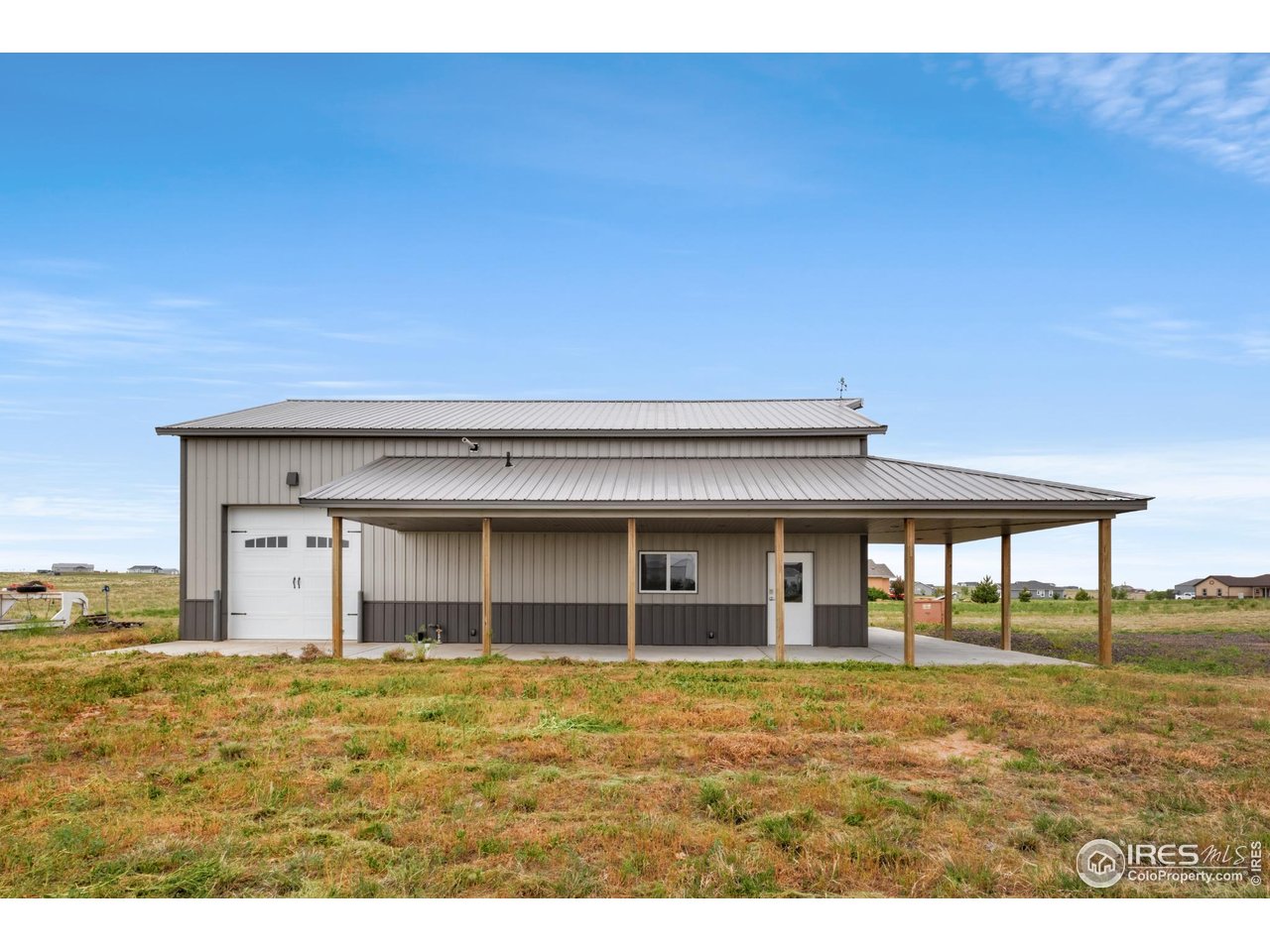7908 P 3 Road Wiggins, CO 80654 - Photo 36 of 40 Convenient 10' overhead door-ideal for easy access and versatile use of shop space.