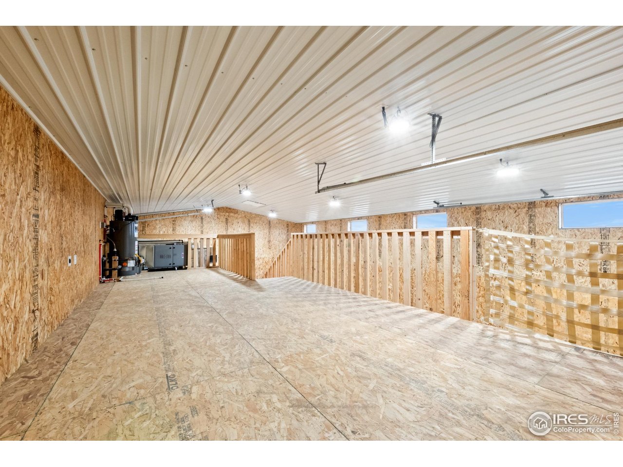 7908 P 3 Road Wiggins, CO 80654 - Photo 38 of 40 12'x28' loft with HVAC and hot water heater-great for storage or a flexible workspace.