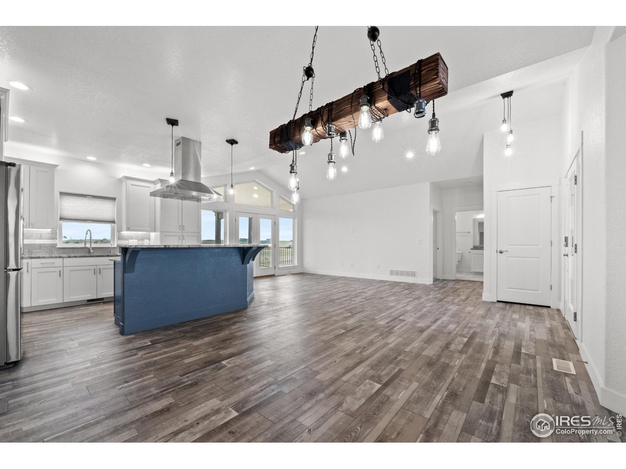 7908 P 3 Road Wiggins, CO 80654 - Photo 6 of 40 Stylish kitchen island with granite countertops and seating, ideal for meal prep and gatherings.