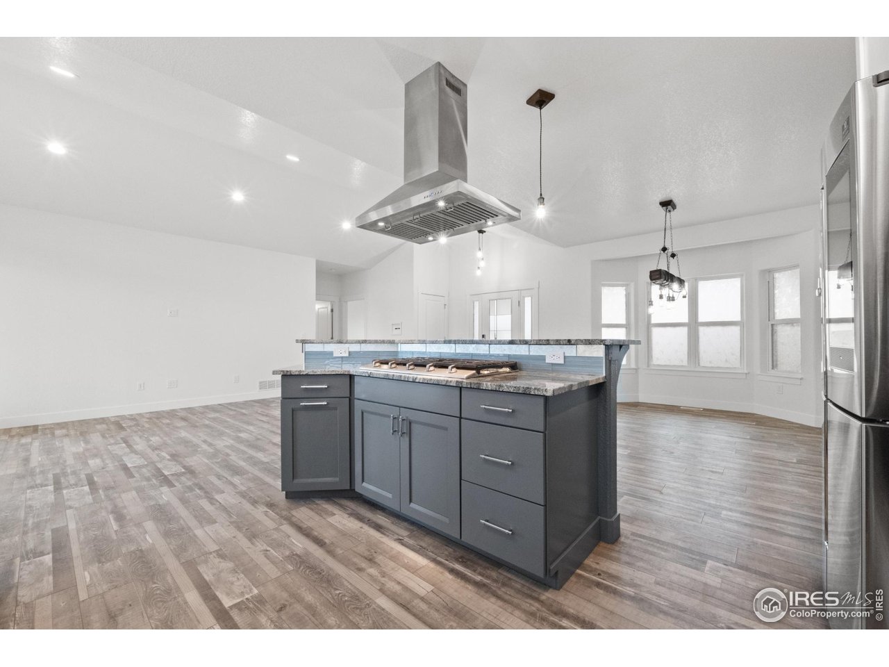 7908 P 3 Road Wiggins, CO 80654 - Photo 9 of 40 Modern stainless steel hood adds a clean, upscale touch above the gas range.