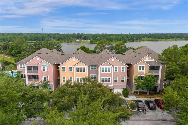 a front view of a houses with a yard and lake view