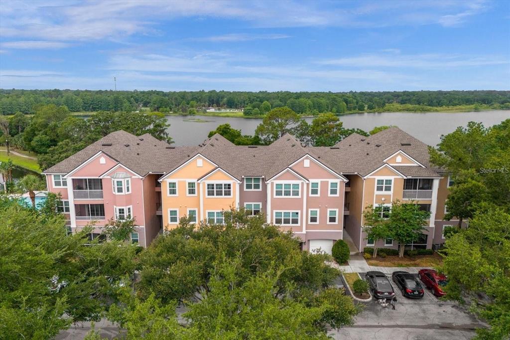3250 Corona Village Way, Unit 102 Orlando, FL 32835 - Photo 1 of 33 a front view of a houses with a yard and lake view