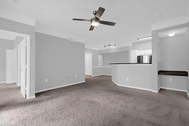 a view of a kitchen with a refrigerator and a ceiling fan