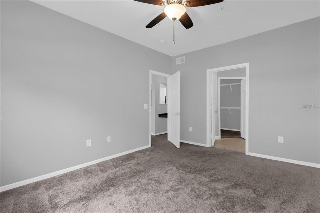 3250 Corona Village Way, Unit 102 Orlando, FL 32835 - Photo 16 of 33 an empty room with chandelier fan