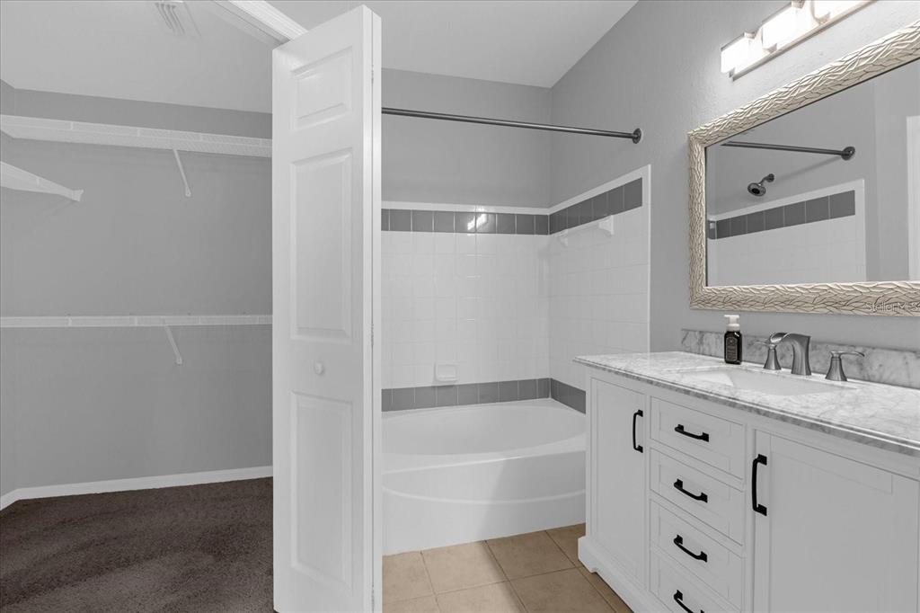 3250 Corona Village Way, Unit 102 Orlando, FL 32835 - Photo 17 of 33 a bathroom with a bathtub and a sink