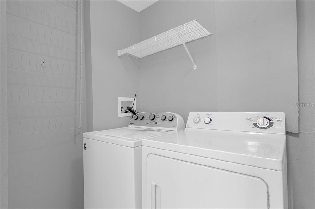 3250 Corona Village Way, Unit 102 Orlando, FL 32835 - Photo 4 of 33 a utility room with dryer and washer