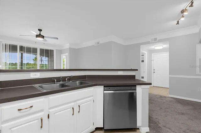 a kitchen with granite countertop a sink and cabinets