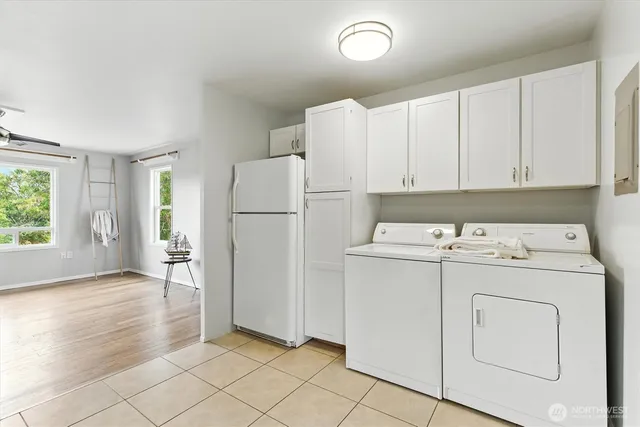 a living room with furniture flat screen tv and a large window