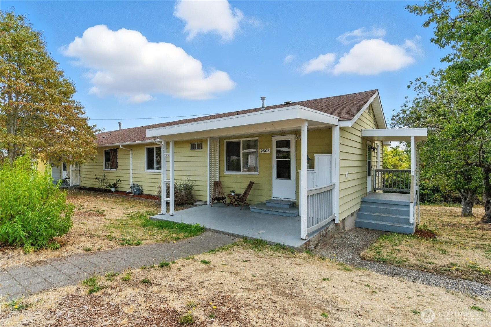 2510 Stephenson Avenue Bremerton, WA 98310 - Photo 2 of 40 a view of a house with a yard and lawn chairs with a large tree