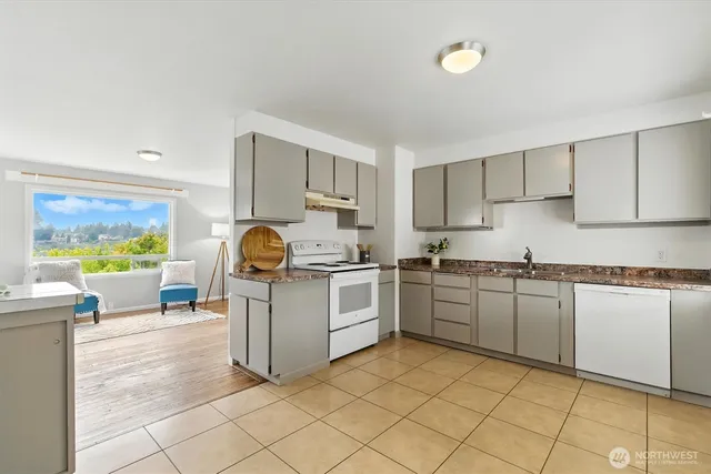 a kitchen with a stove top oven sink and cabinets